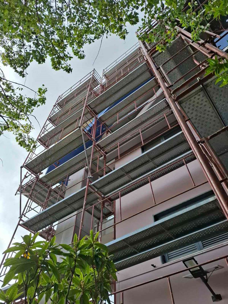 Scaffolding for balcony repairs on an apartment building