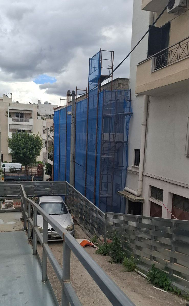 Scaffolding with blue safety netting on an apartment building