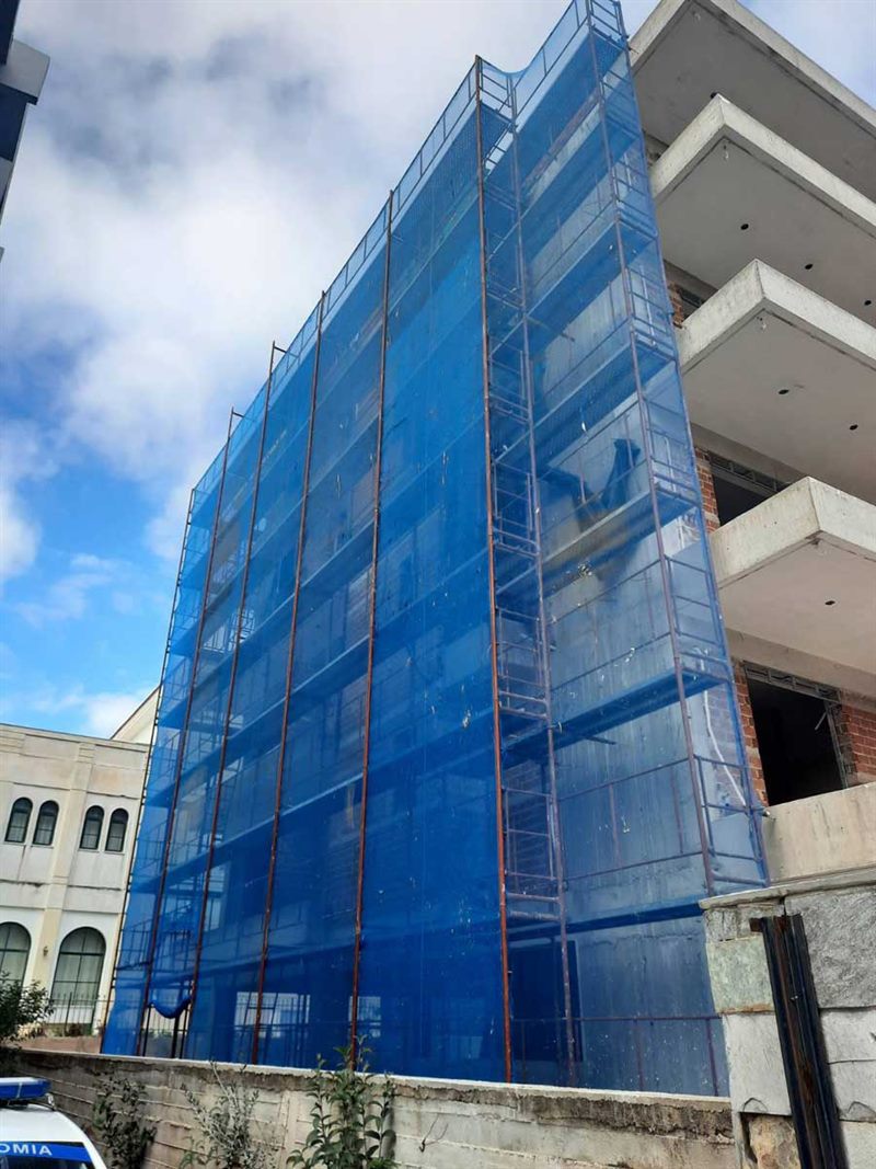 Scaffolding with blue safety netting on an apartment building