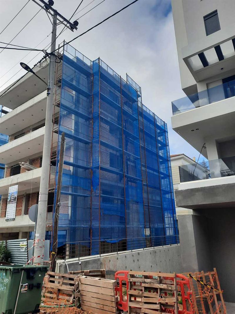 Scaffolding with blue safety netting on an apartment building