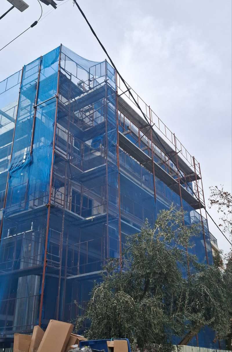 Scaffolding with blue safety netting on an apartment building