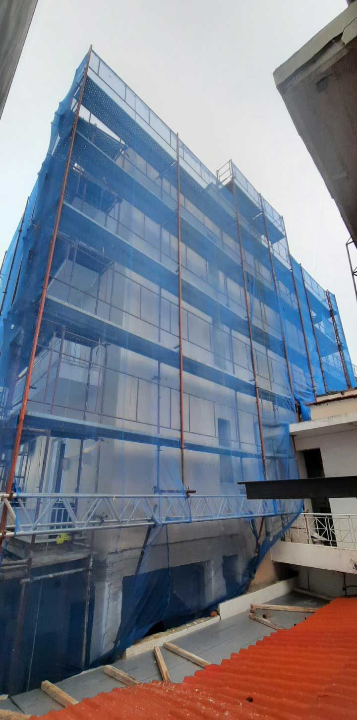 Scaffolding with blue safety netting on an apartment building