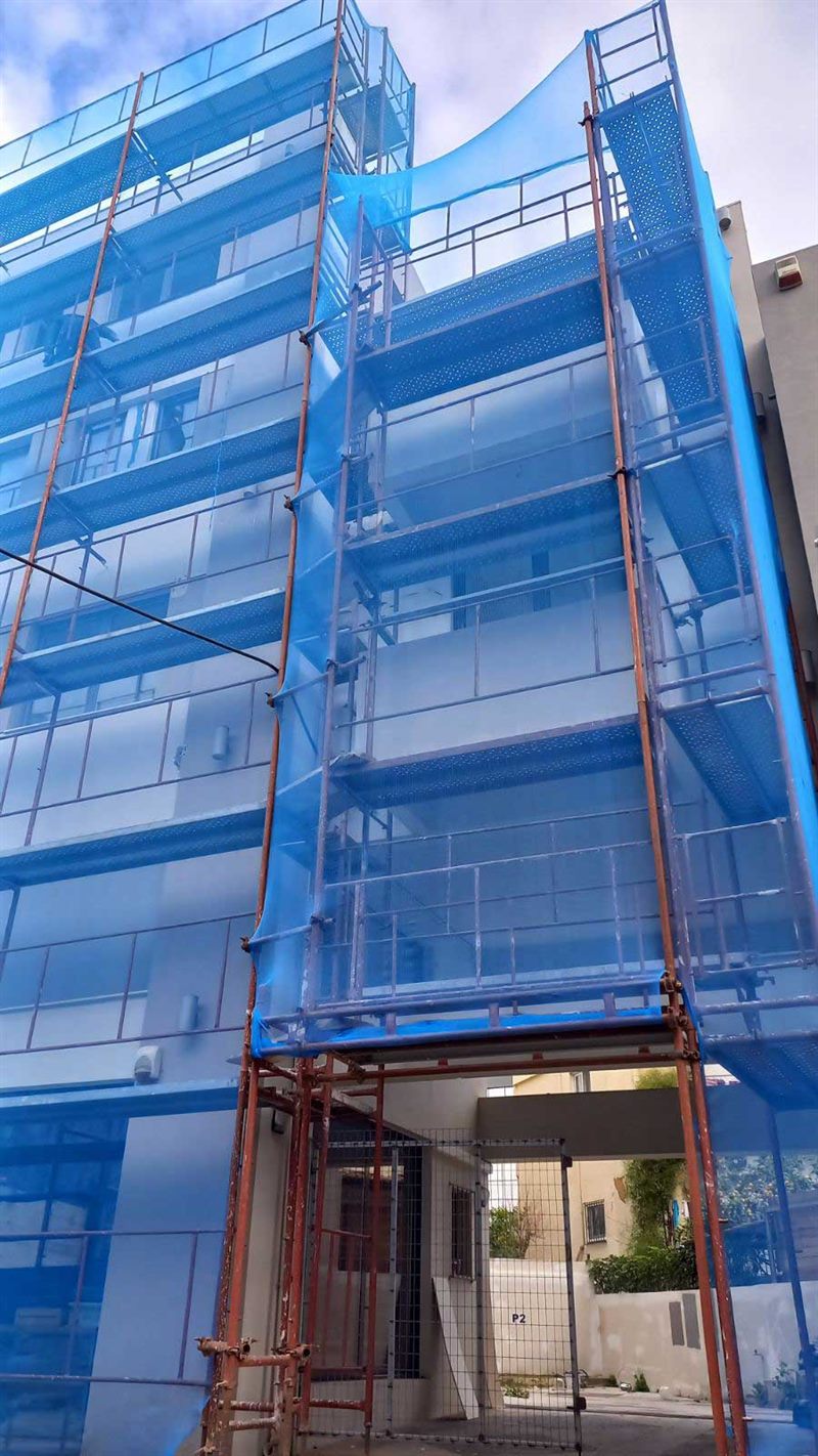 Scaffolding with blue safety netting on an apartment building