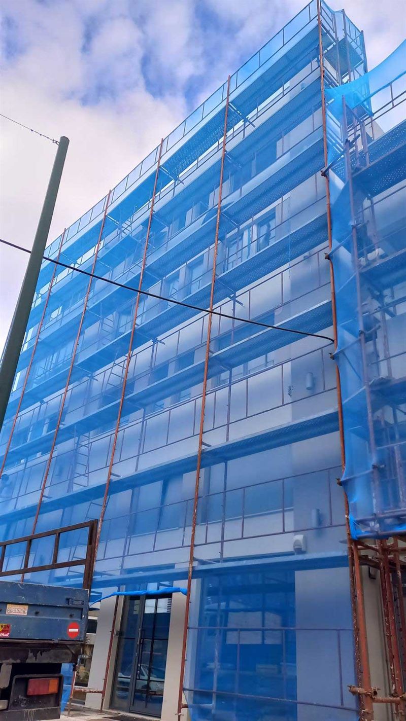 Scaffolding with blue safety netting on an apartment building
