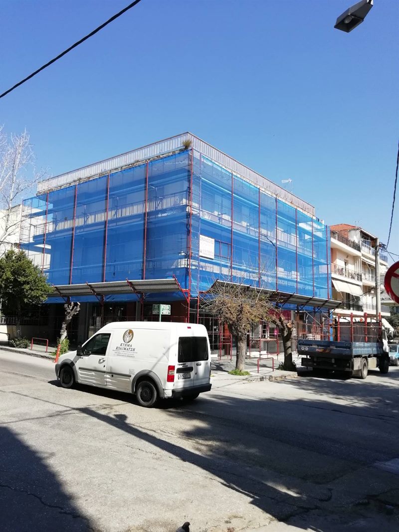 Scaffolding with blue safety netting on an apartment building
