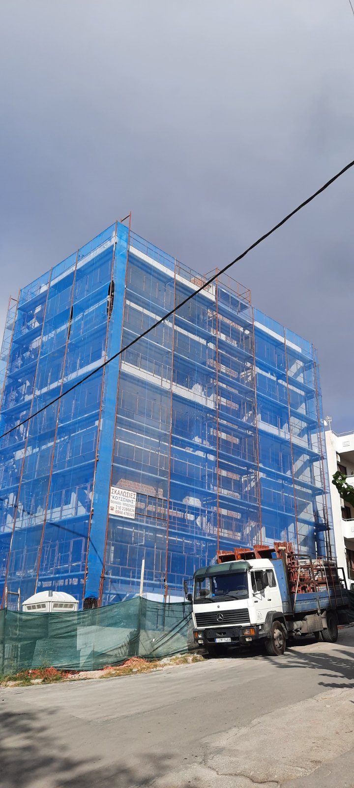Scaffolding with blue safety netting on an apartment building