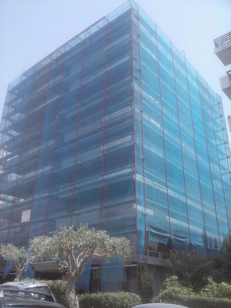 Scaffolding with blue safety netting on an apartment building