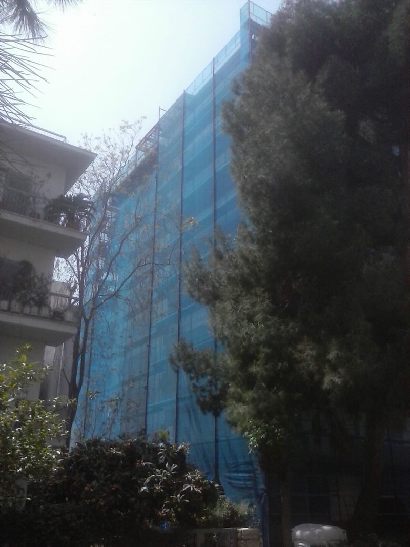 Scaffolding with blue safety netting on an apartment building