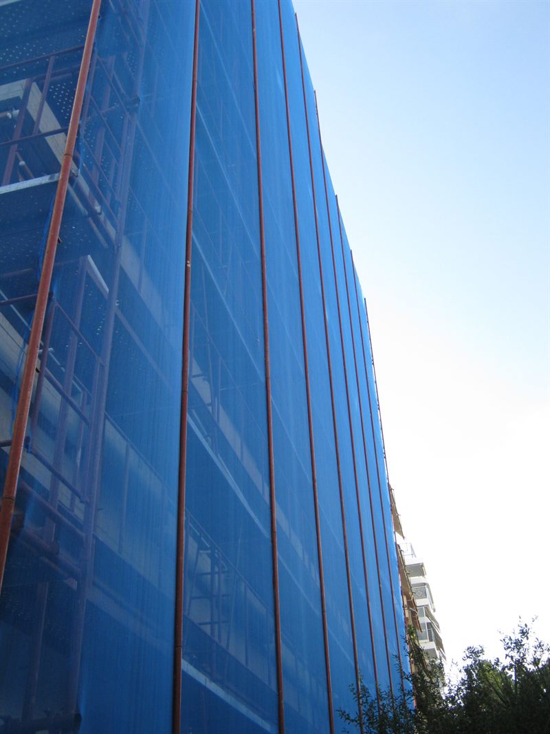 Scaffolding with blue safety netting on an apartment building