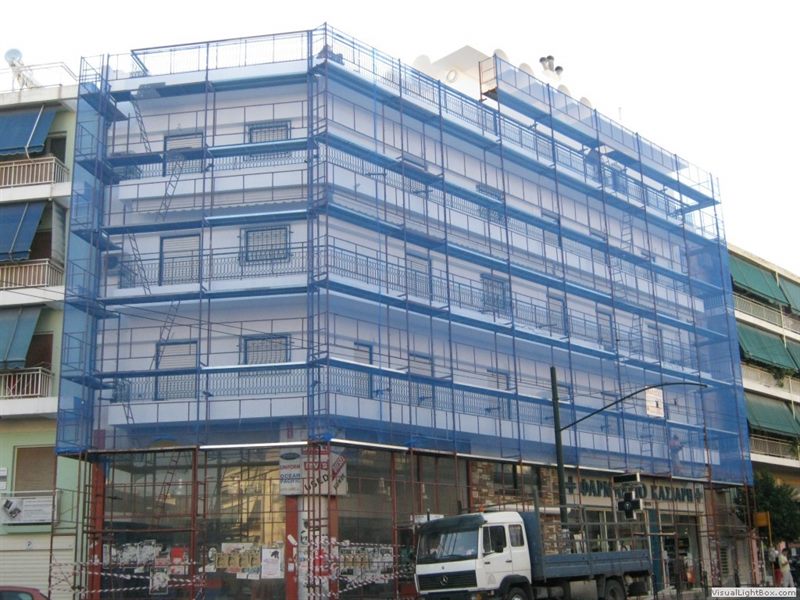 Scaffolding with blue safety netting on an apartment building
