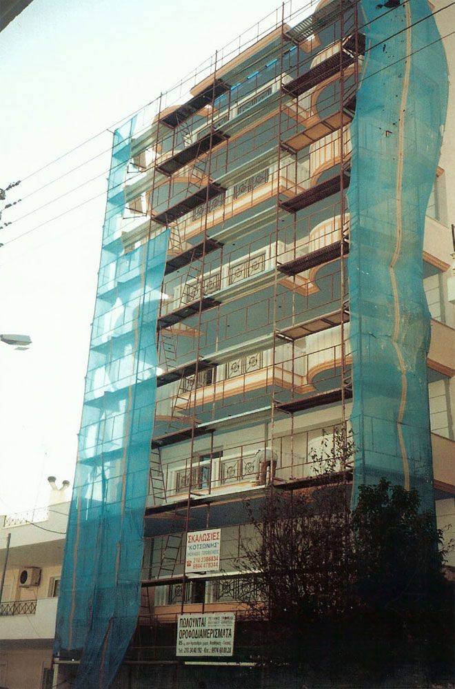 Scaffolding with blue safety netting on an apartment building