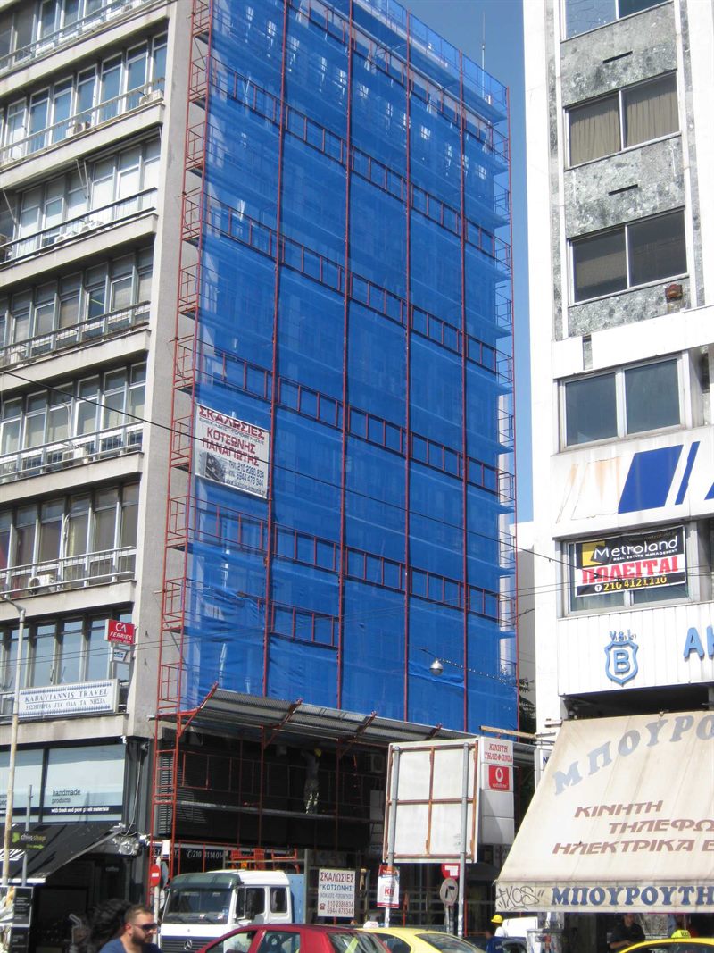 Scaffolding with blue safety netting on an apartment building in Athens