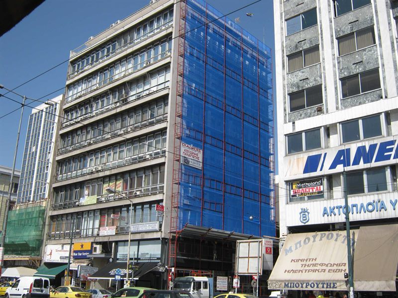 Scaffolding with blue safety netting on an apartment building in Athens