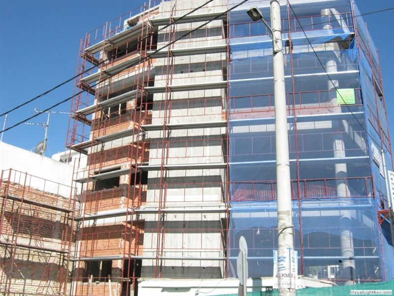 Scaffolding with blue safety netting on an apartment building in Ekali