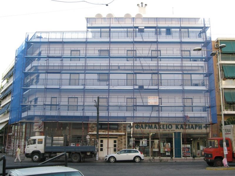 Scaffolding with blue safety netting on an apartment building in Galatsi