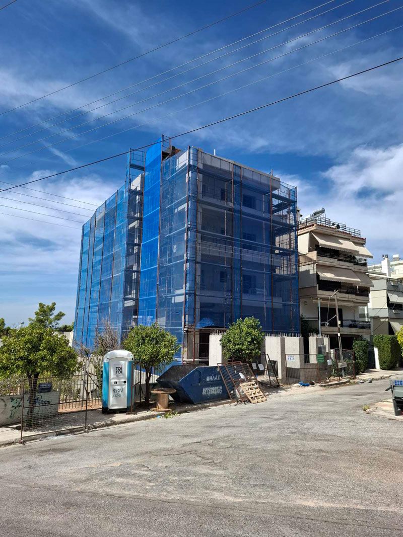Scaffolding with blue safety netting on an apartment building in Ilion