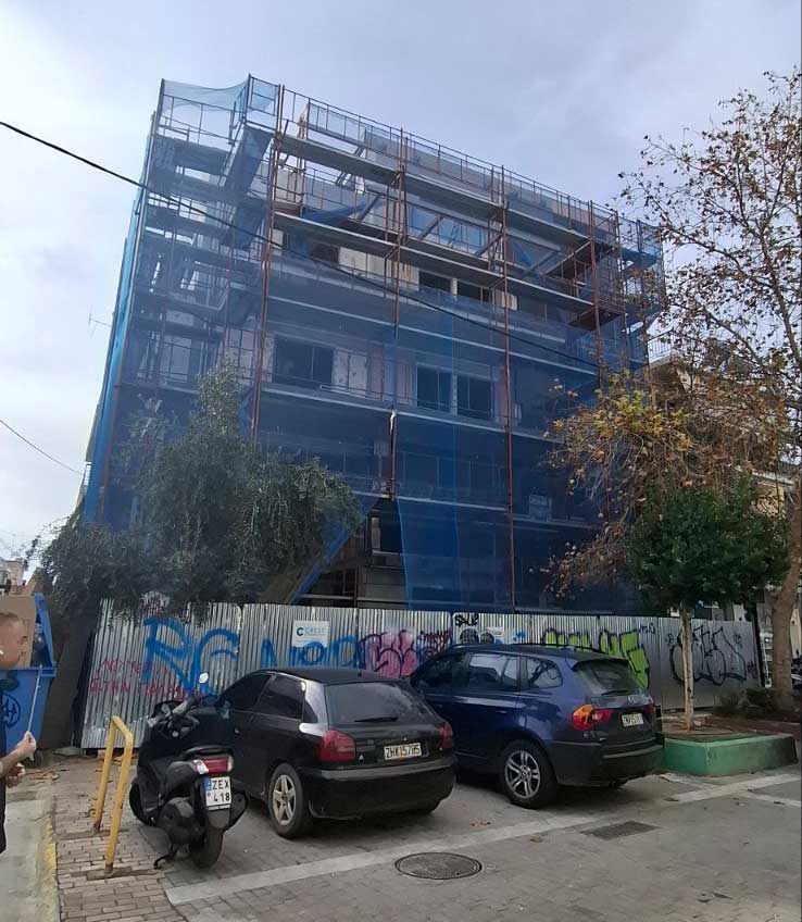 Scaffolding with blue safety netting on an apartment building in Ilion