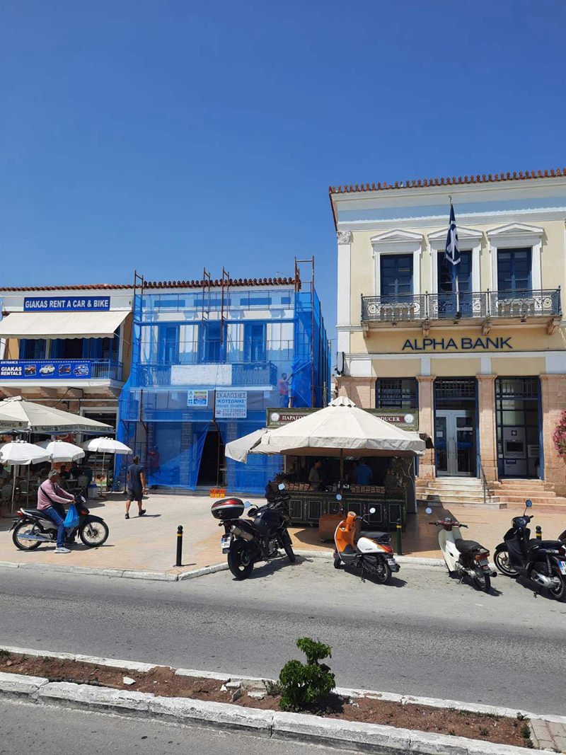 Scaffolding on a building with shops