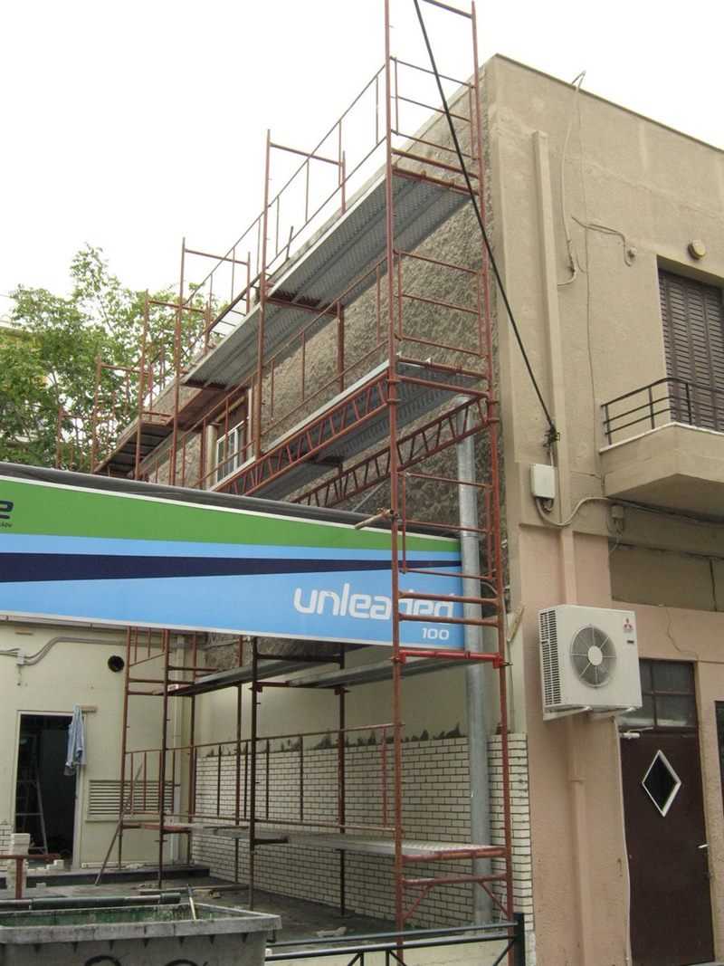 Scaffolding on a building with shops